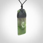 British Coloumbian jade toki koru pendant. Hand carved in New Zealand. Hand made British Coloumbian Jade jewellery. Provided with an adjustable cord and packaged in a woven kete pouch.